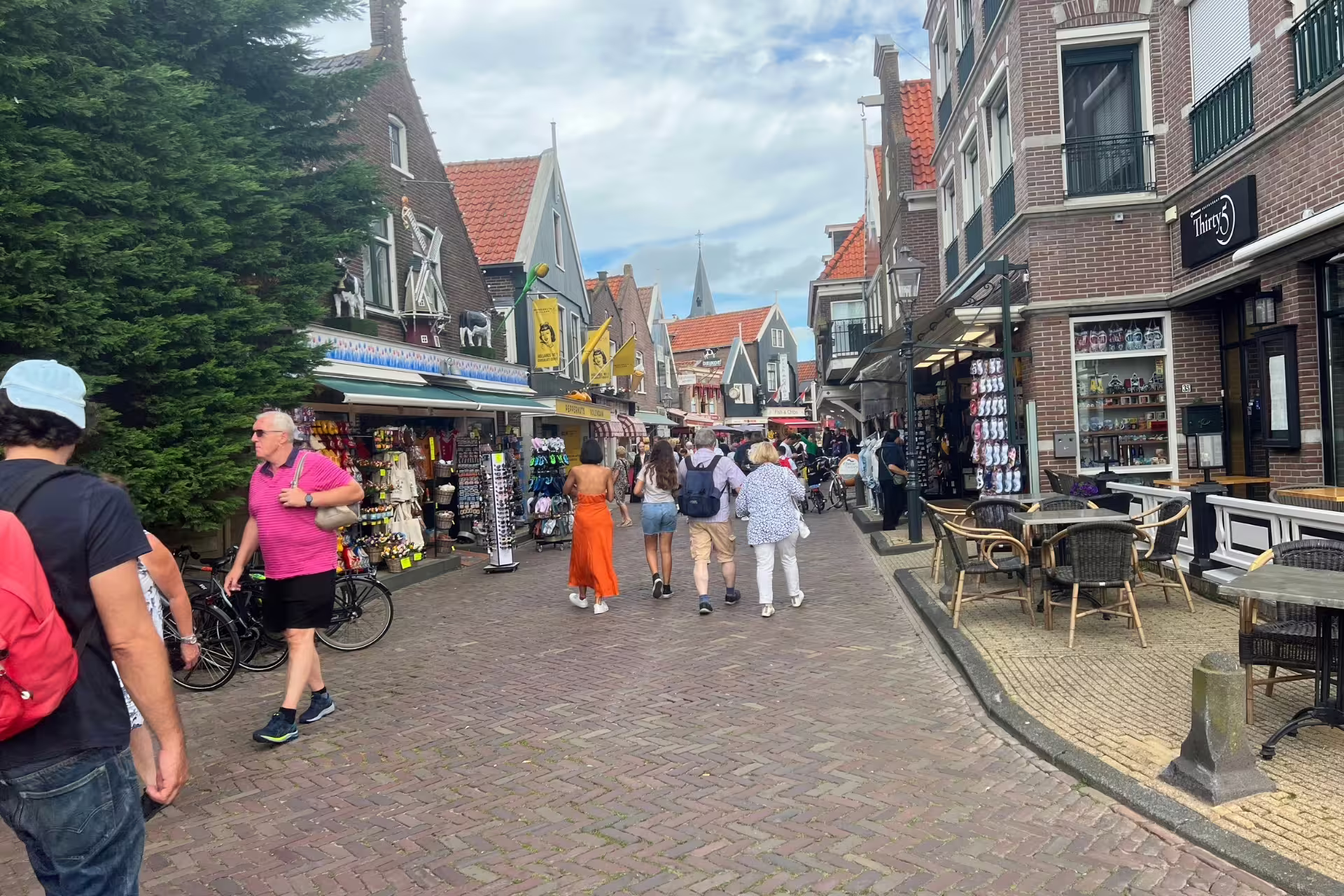 Volendam village street with shops and cafes, popular stop on Amsterdam Zaanse Schans Volendam Giethoorn tour