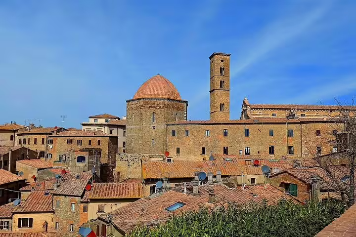 Historic Volterra skyline with medieval stone buildings and domed church seen on a private Tuscany day tour from Florence