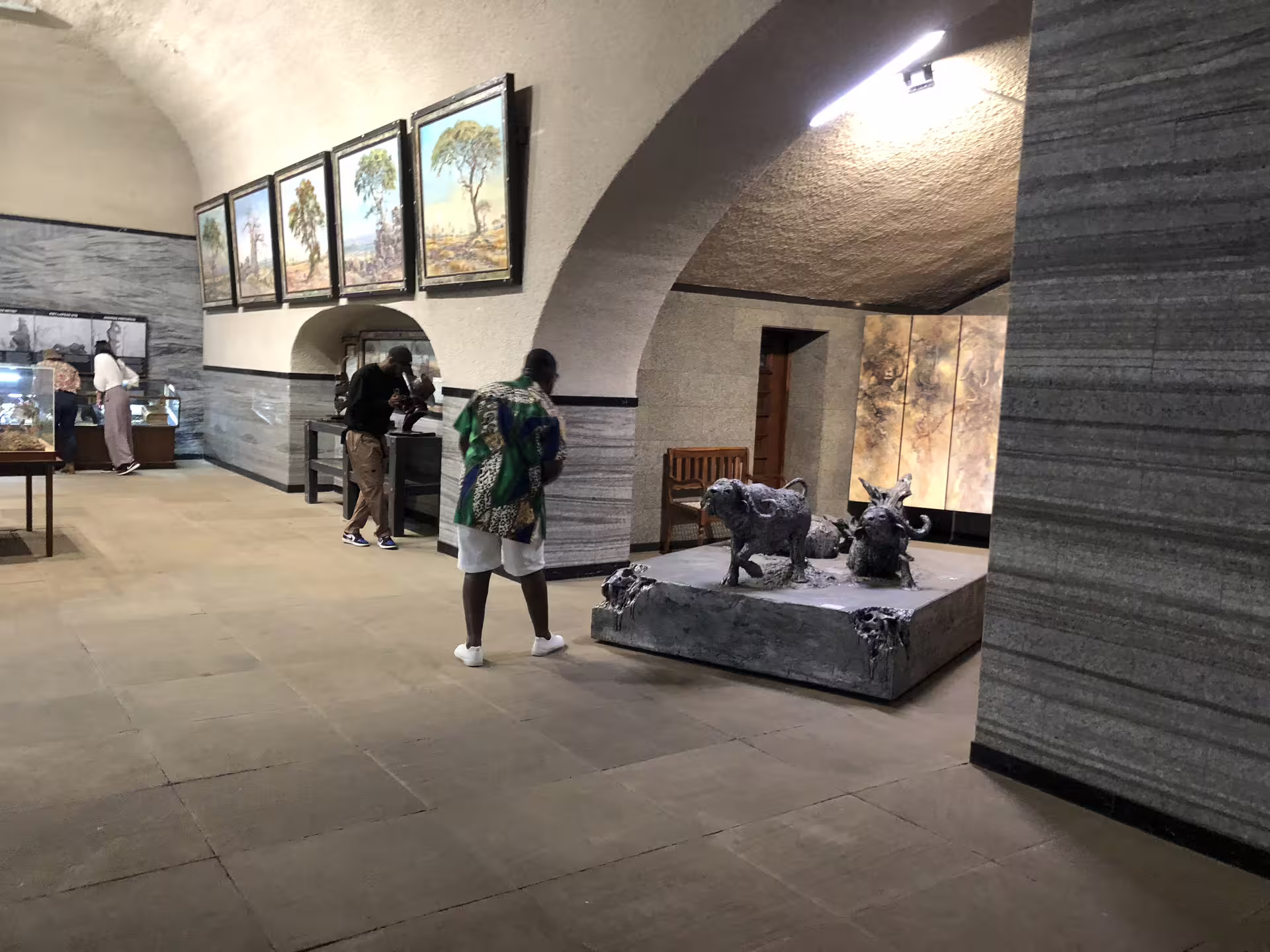 Visitors engaging with exhibits inside the Voortrekker Monument on a half-day Pretoria city tour.
