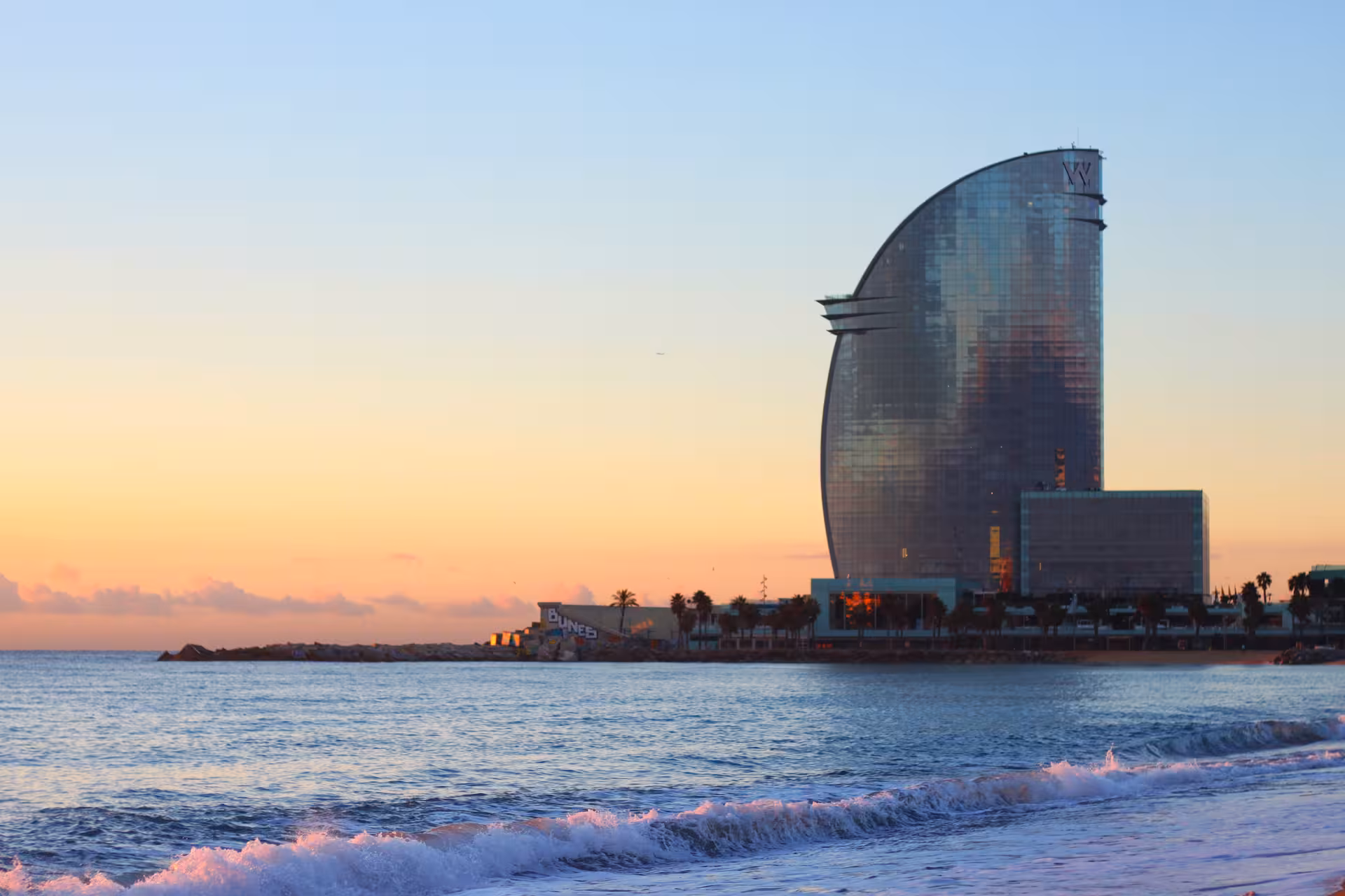 W Barcelona Hotel sail building at Barceloneta beach at sunset, featured on a half-day private city tour