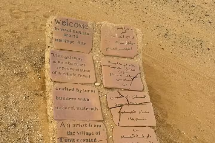 Wadi El-Hitan World Heritage Site welcome stone sign in Fayoum Oasis on private full-day tour from Cairo