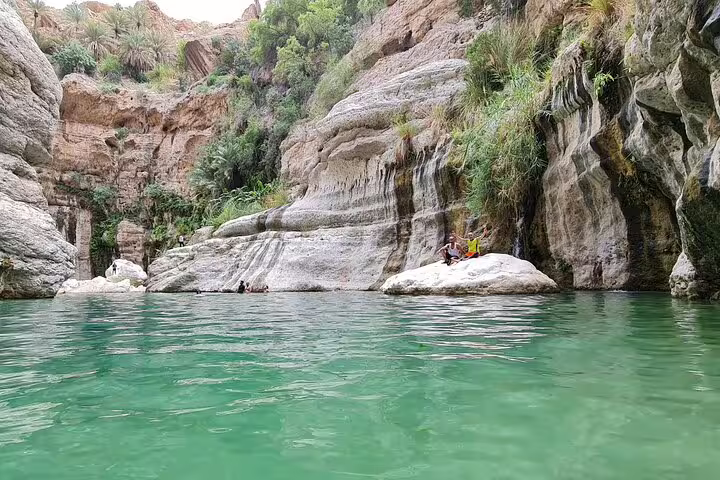 Scenic view of the emerald waters and lush cliffs of Wadi Tiwi, a highlight of the Muscat private day tour.