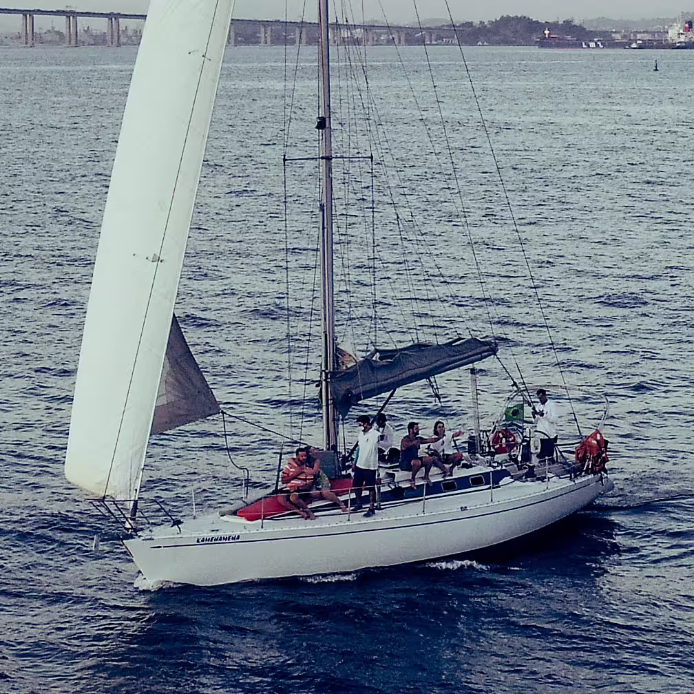 Group enjoying a sailing tour on a sleek yacht, capturing the essence of the Wake Up and Sail experience.