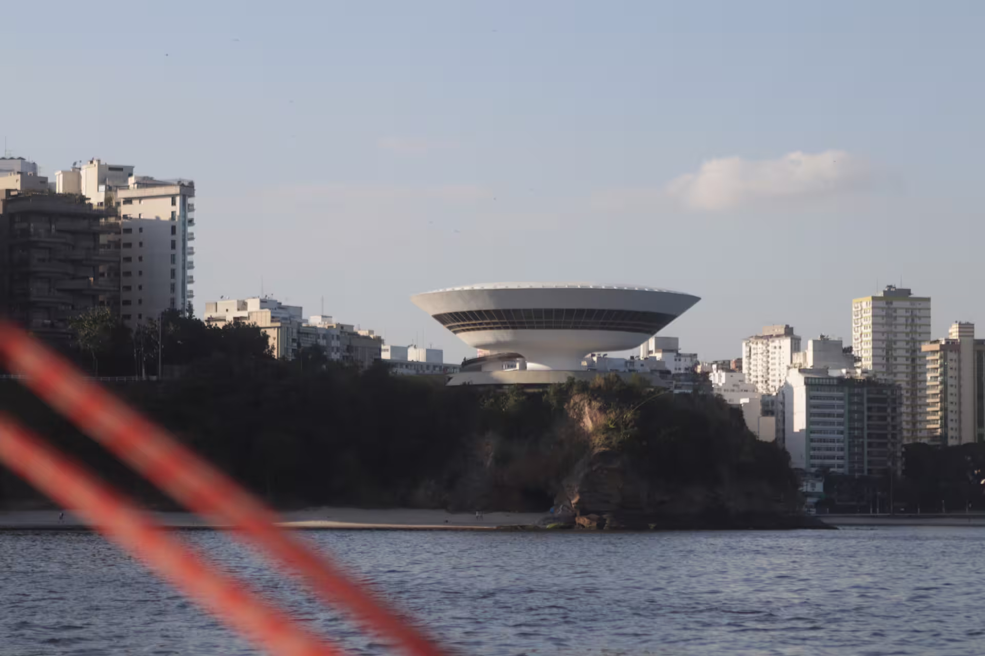View of the futuristic Niterói Contemporary Art Museum from a sailing boat on Guanabara Bay.