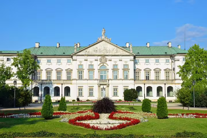 White Baroque palace with green roof and formal garden in Warsaw's Muranow district