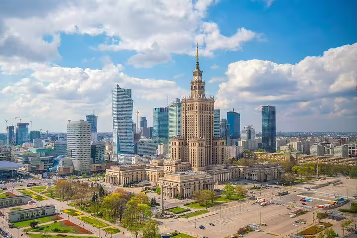Aerial view of Warsaw cityscape with Palace of Culture and Science tower surrounded by modern skyscrapers