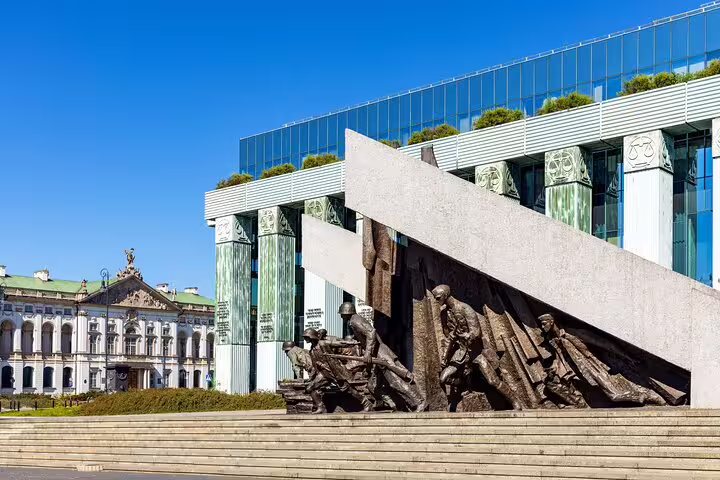 Warsaw Uprising Monument bronze sculptures beside Supreme Court building on clear sunny day