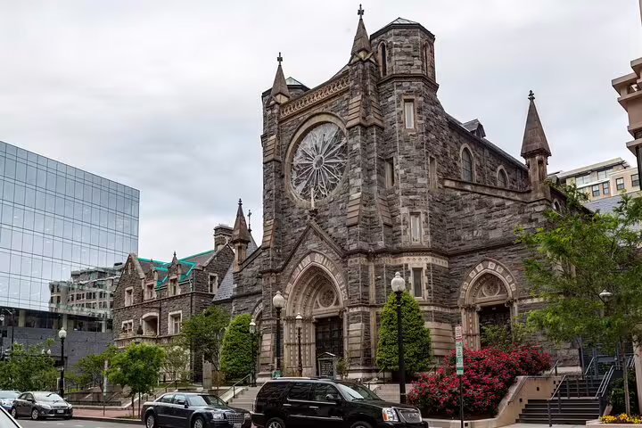 Historic stone church with rose window and Gothic architecture on a Washington DC street