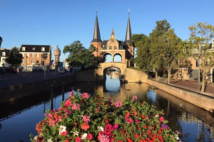 Historic Waterpoort gate over Sneek canal with flowers, Friesland highlight on the Northern Highlights Tour from Amsterdam