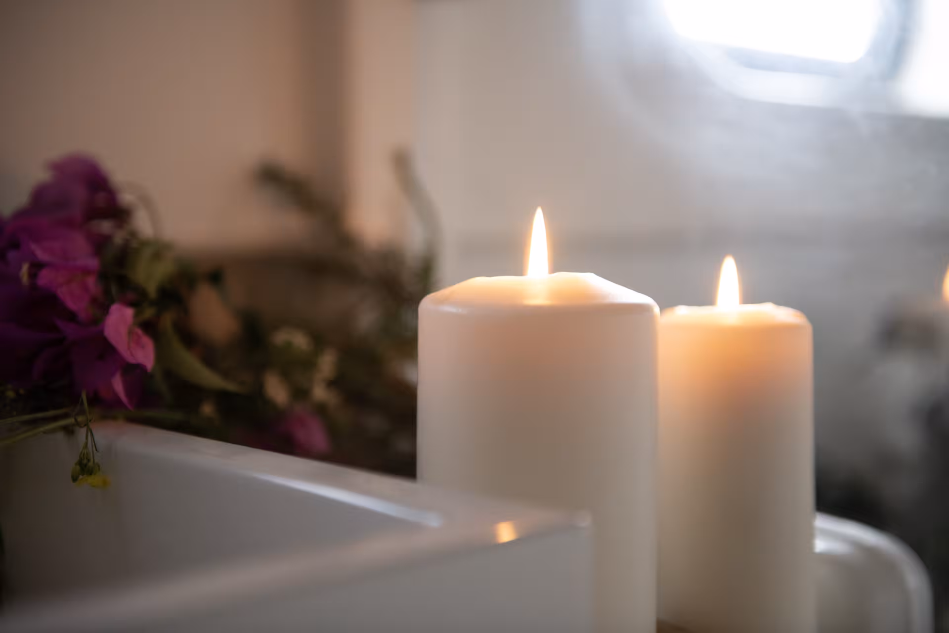 Spa-style bath with lit candles and flowers, perfect for Wellness & Sea Breeze relaxation retreat by the sea