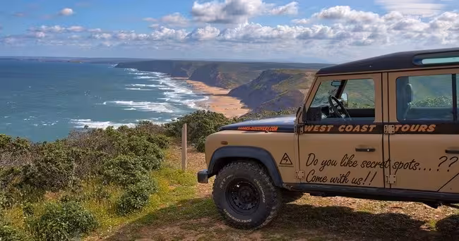 Explore stunning coastal views on a thrilling West Coast day trip in an off-road vehicle, perfect for adventure seekers.
