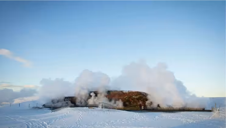 Geothermal steam rising over snowy landscape in West Iceland winter scene