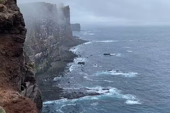 Dramatic misty sea cliffs along the rugged Westfjords coastline in Iceland