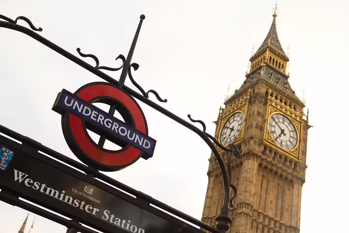 London Underground sign at Westminster Station with Big Ben in the background, highlighting iconic landmarks on a private tour.