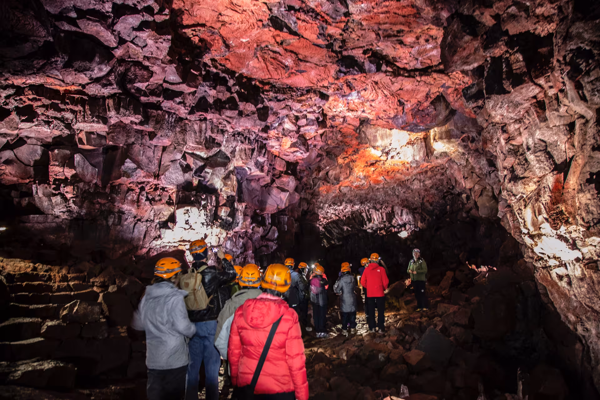 Whale tail emerging from the ocean with lava cave imagery representing Iceland adventure experiences