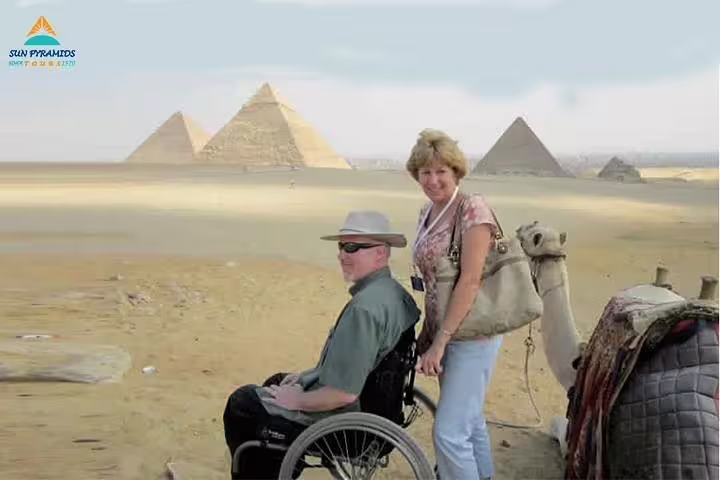 Wheelchair traveler with companion at Giza Pyramids, accessible Egypt tour from Alexandria to Abu Simbel