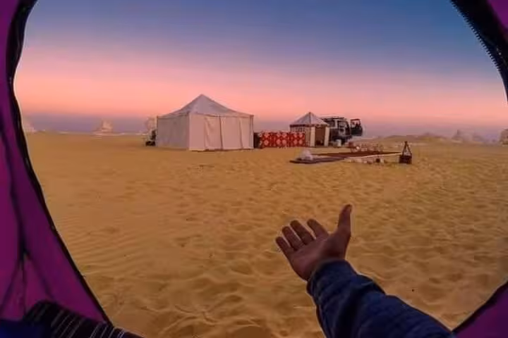 View from tent toward Sahara camp at dusk in Egypt on White Desert & Black Desert 2-day private tour