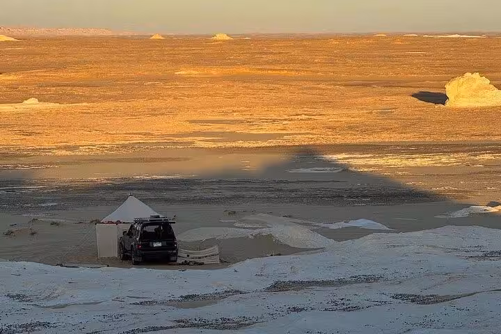 White Desert camp with 4x4 and tent at golden sunset, part of a 2-day private White & Black Desert safari Egypt