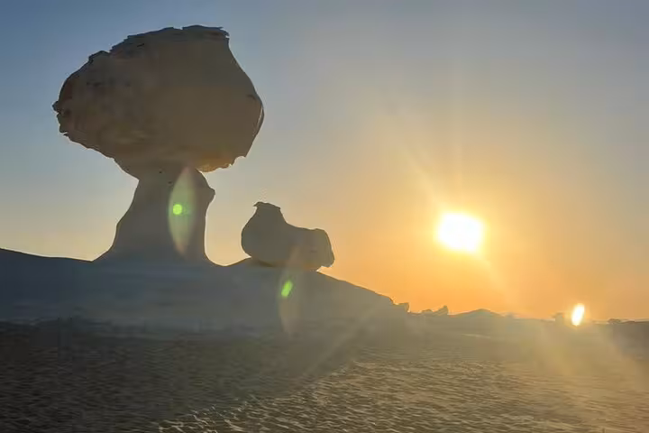 Sunset over White Desert mushroom rock formations on 3-day Bahariya camping tour in Egypt Sahara