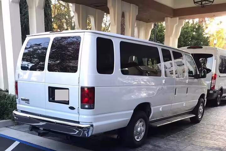 White Ford passenger van for group private transfer from Belize city to Belize Airport BZE