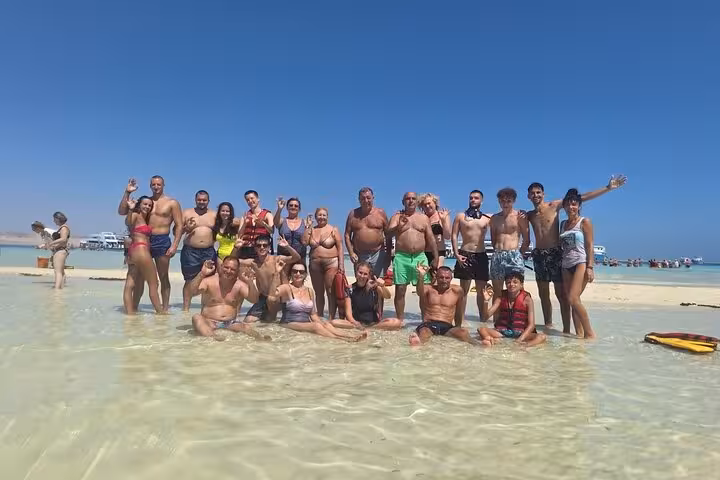 Group photo in shallow lagoon at White Island, Ras Mohammed National Park tour from Sharm El Sheikh by boat