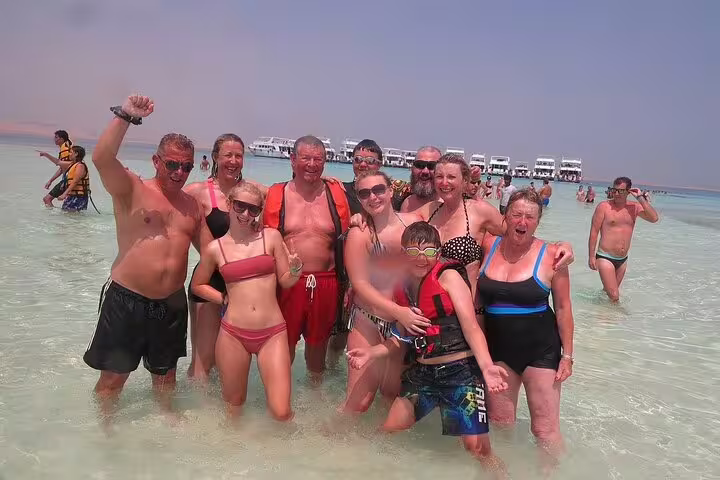 Happy group in shallow Red Sea at White Island on VIP boat snorkeling day trip from Sharm El Sheikh