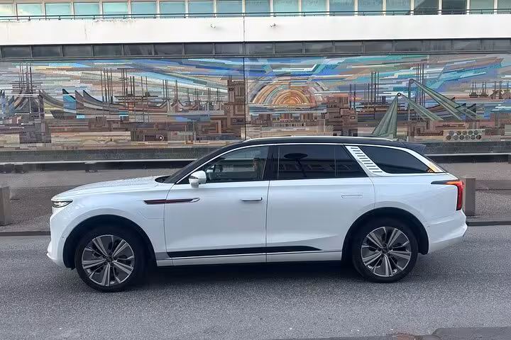 White luxury SUV parked on city street for private transfer service in Reykjavik