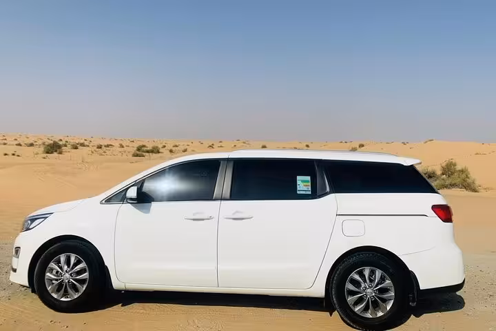 White minivan for Dubai to Abu Dhabi private transportation, comfortable door-to-door transfer across UAE