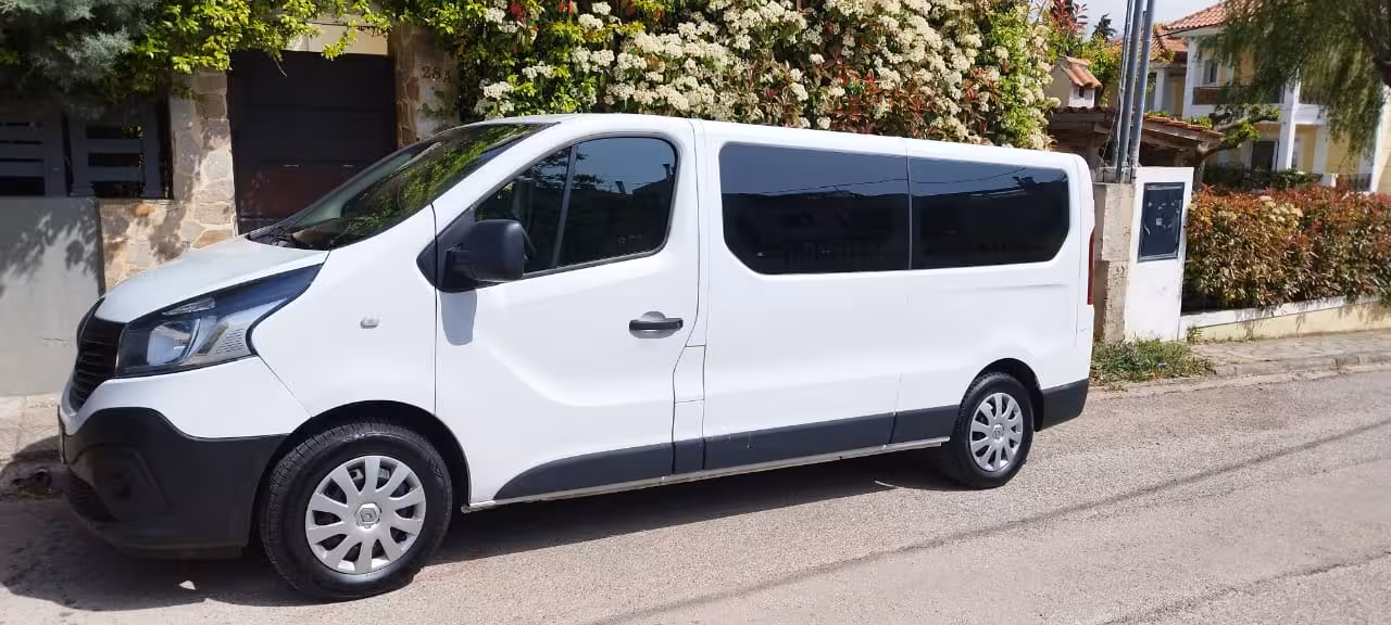 White minivan parked on a residential street, comfortable private transfer service for airport and hotel rides