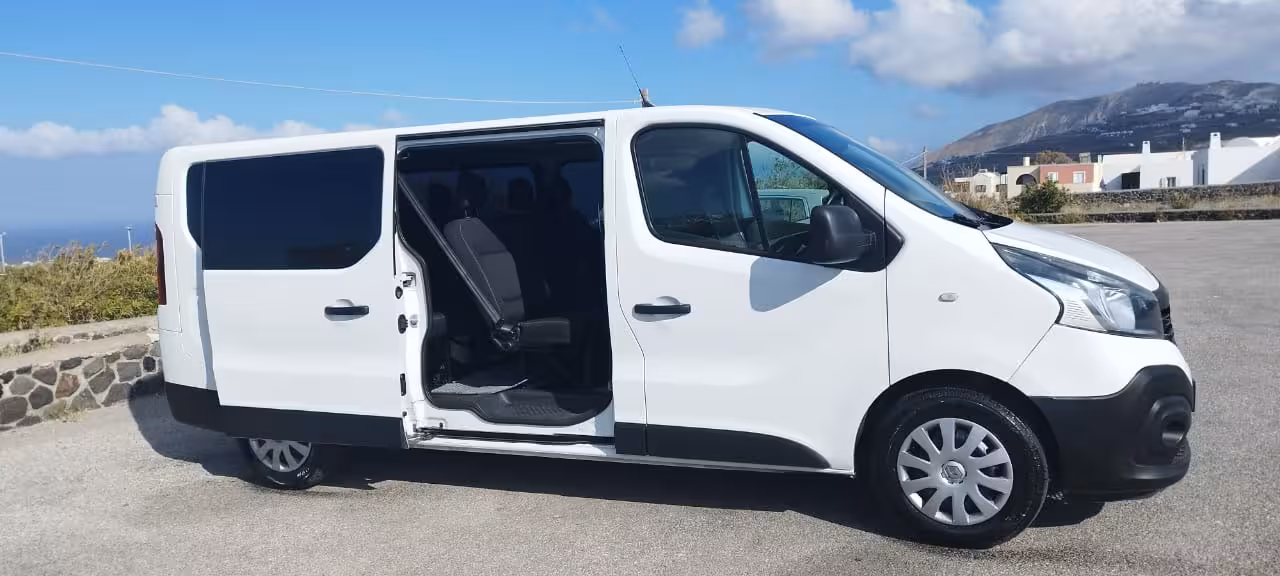 White passenger van with sliding door open, ideal for shared transfer service and airport or hotel pickup