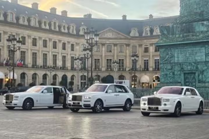 Three white Rolls Royce luxury cars parked at Place Vendôme in Paris, France