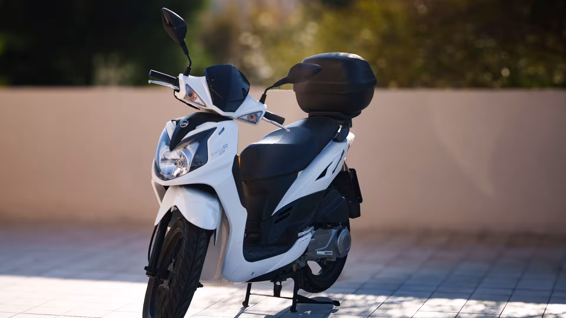 Sleek white scooter parked in Olbia, ideal for exploring scenic routes and coastal views.
