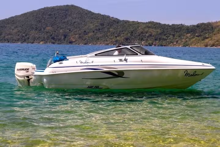 Sleek white speedboat on clear turquoise waters of Paraty, ideal for exclusive boat tours and scenic coastal exploration.