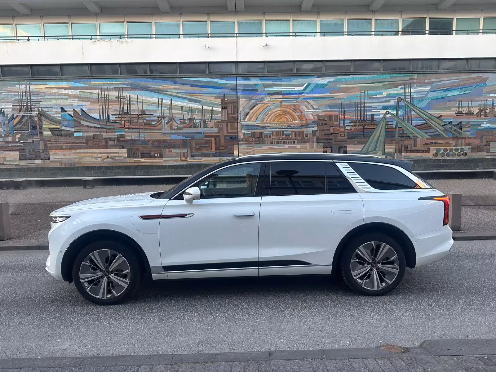 White luxury SUV parked at Reykjavik cruise port terminal for private airport transfer to KEF
