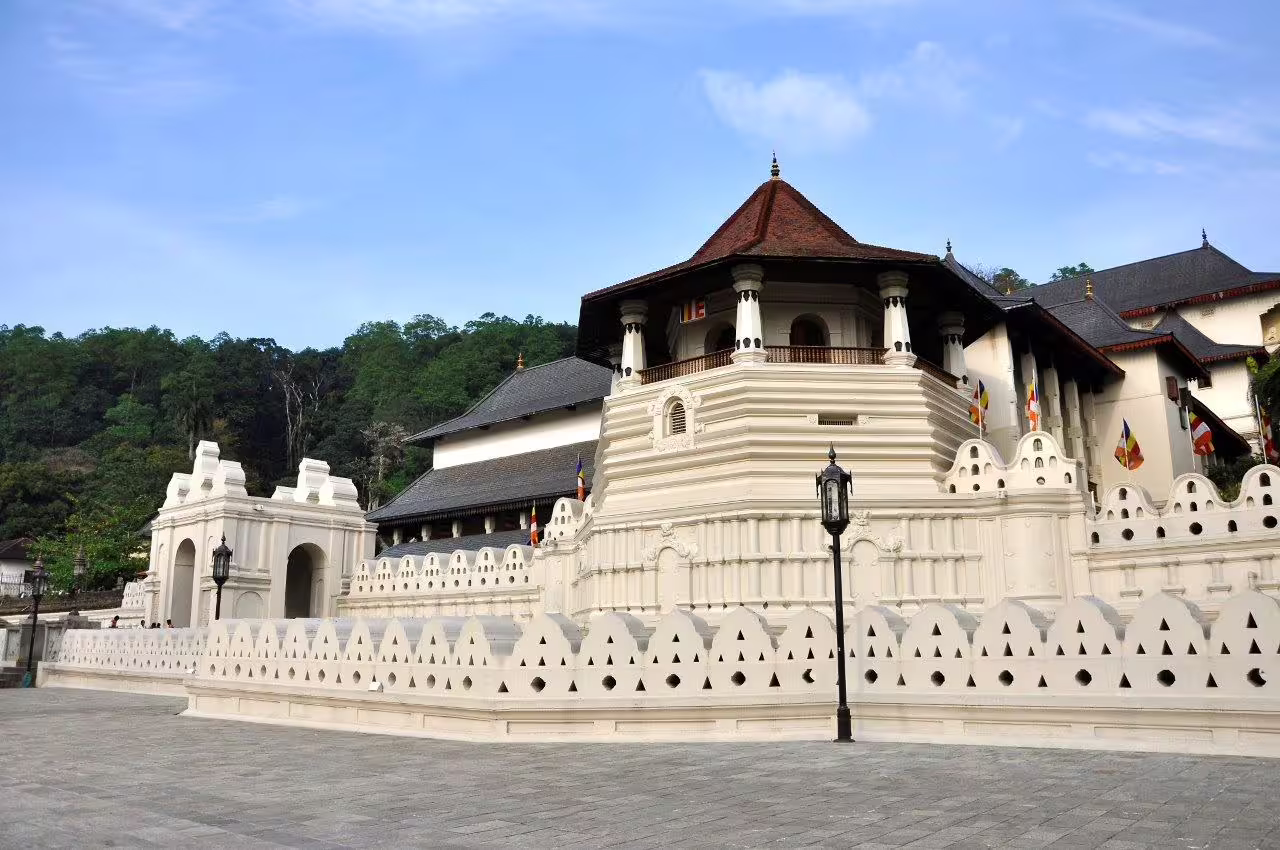 Majestic white temple with intricate architecture set against lush greenery, perfect for a serene romantic tour.