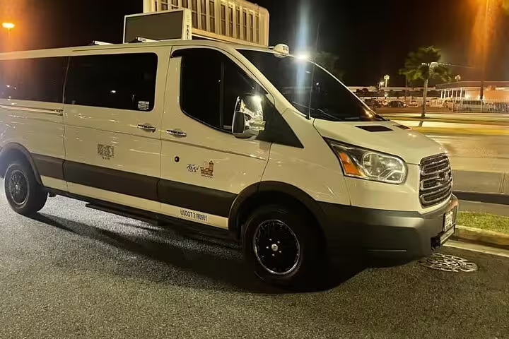 White Ford Transit van ready for private SDQ Airport to Las Galeras round trip nighttime transfer service