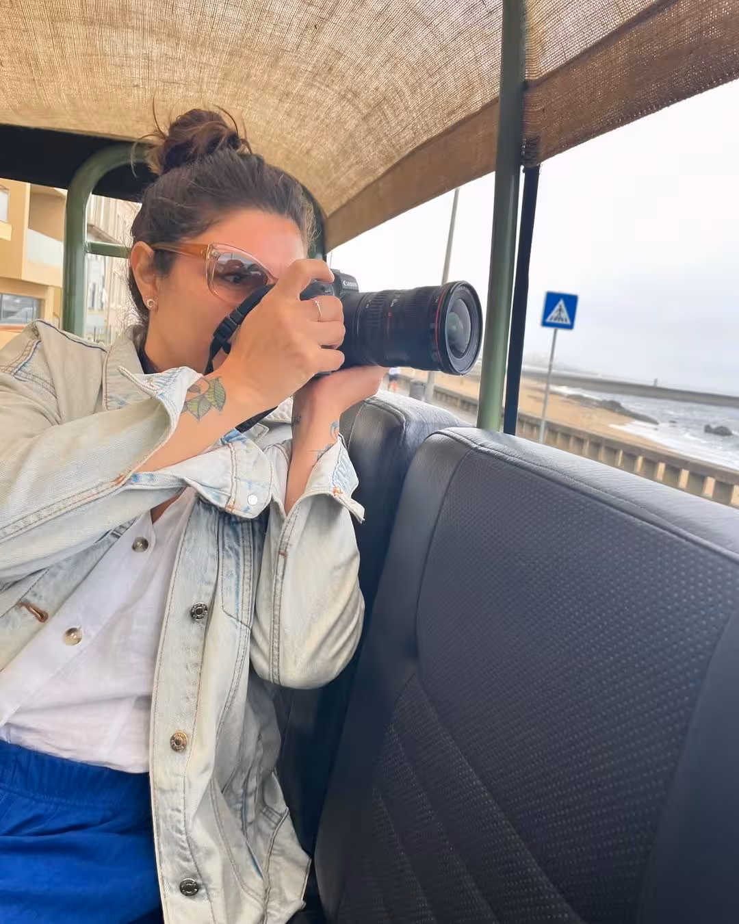 Wildlife photographer spotting coastal birds by the ocean during a North Coast Birdwatching Adventure excursion