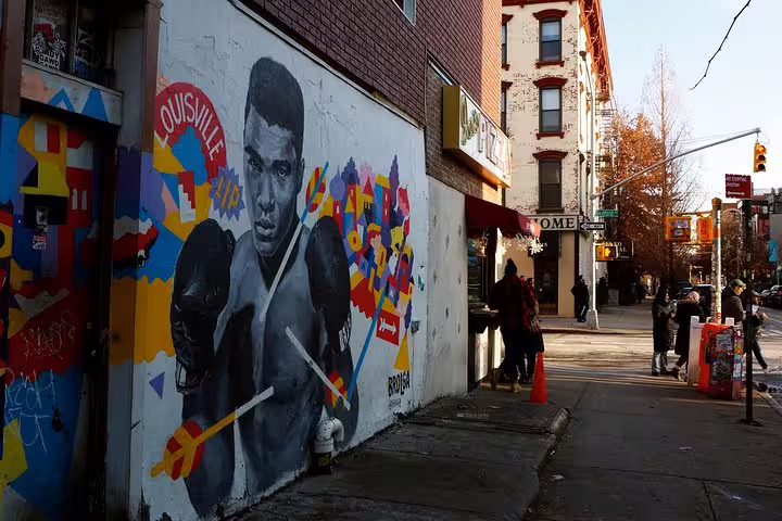 Colorful street art mural of a boxer with 'Louisville' text on a Williamsburg Brooklyn building wall