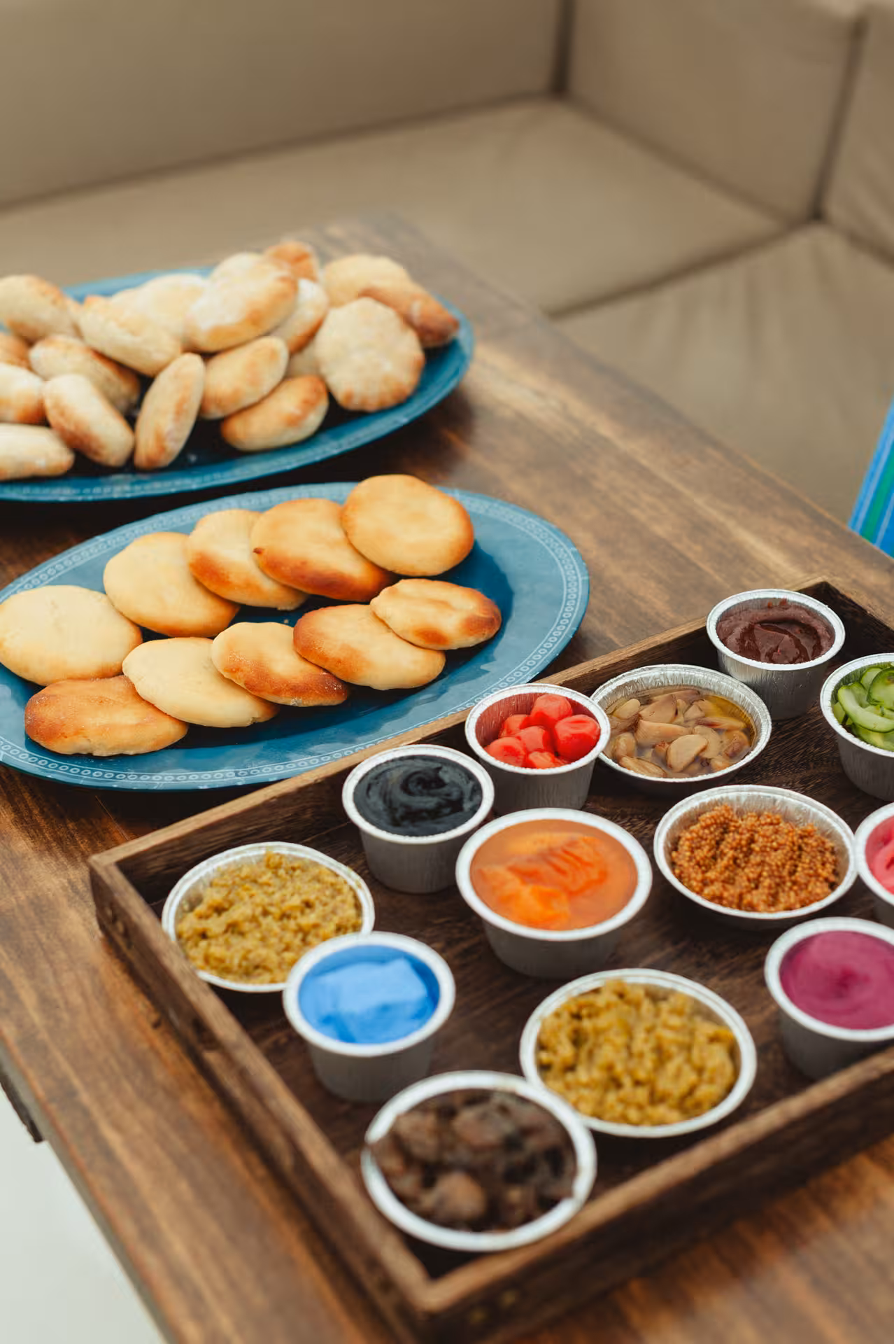 Assorted pastries and colorful dips on a wooden tray, tasty snacks for a Wine & Art paint session