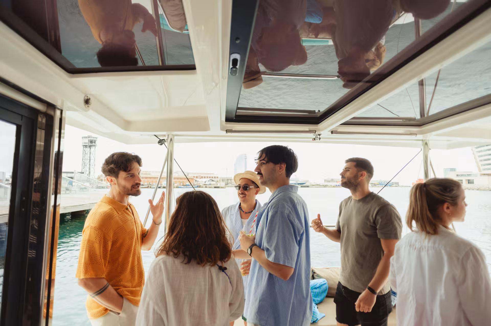 Group chatting on a yacht during a Wine & Art tour, relaxed wine tasting cruise with creative vibes by the harbor