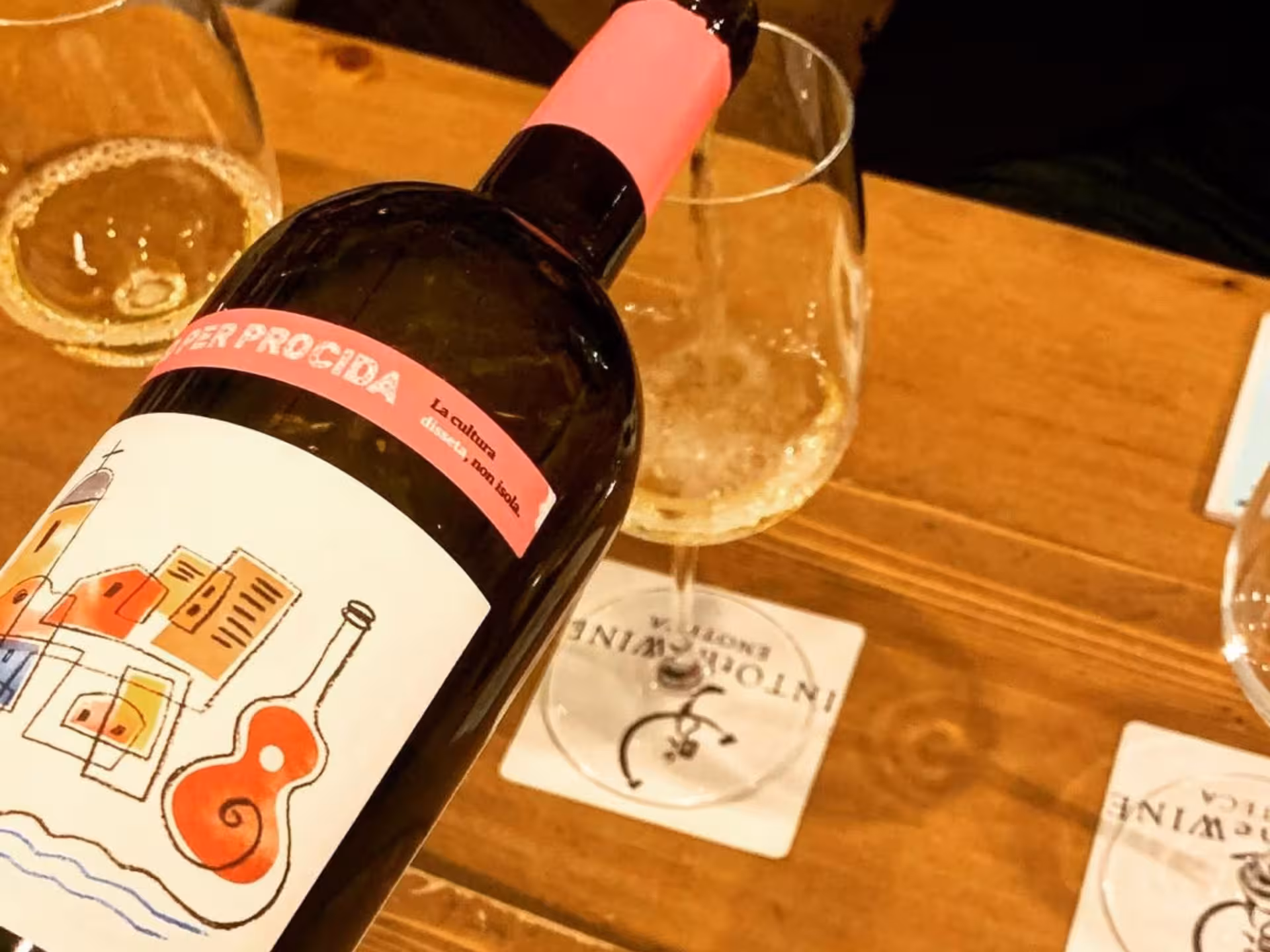 Close-up of a unique wine label with glasses ready for a tasting session in a Naples wine experience.