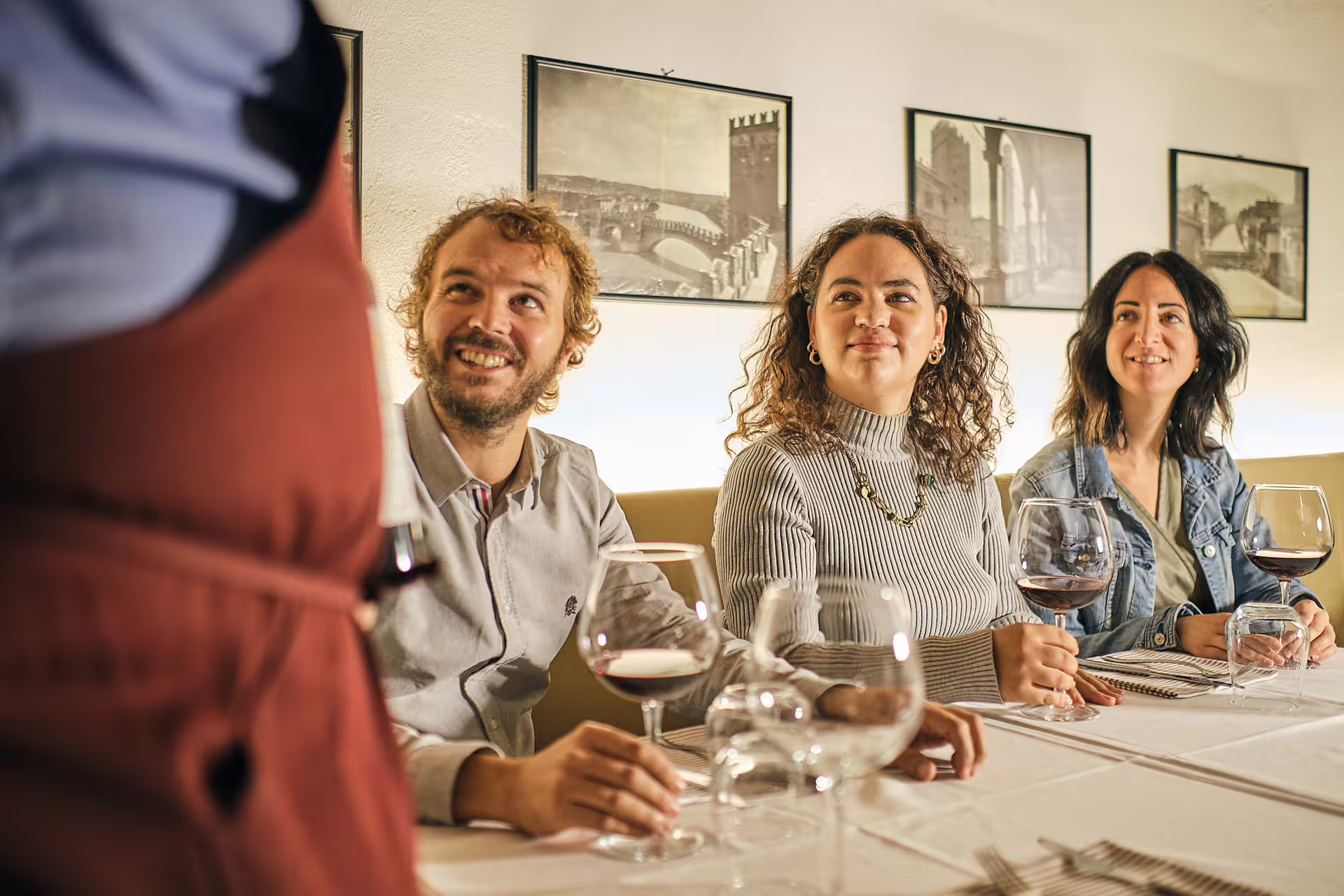 Guests enjoying guided wine tasting near Juliet’s House in Verona, sampling local reds at a traditional osteria
