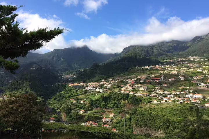 Scenic hillside vineyards and charming village under a vibrant sky, perfect for a wine tour, tasting experience, and 4x4 adventure.