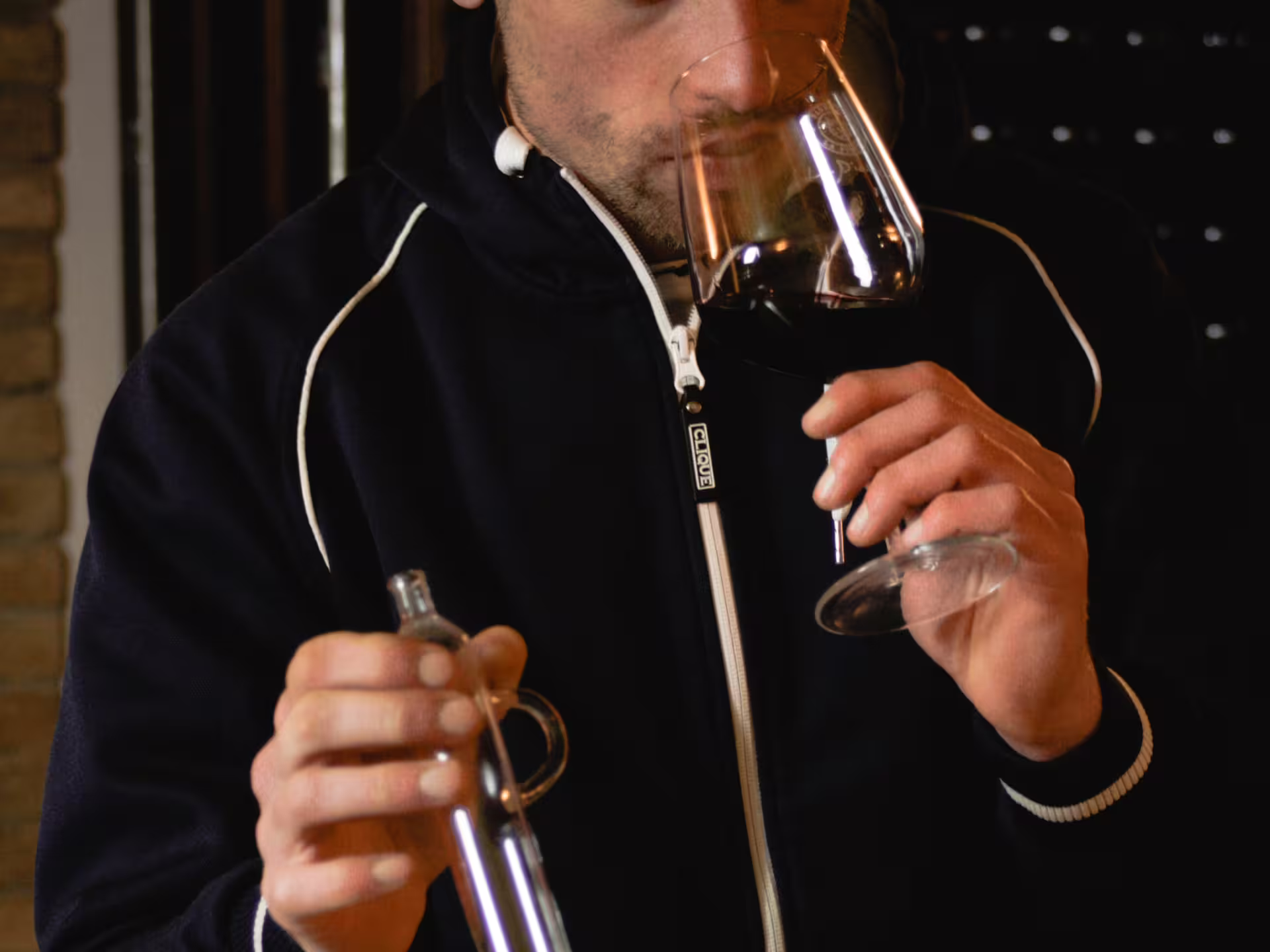 Winemaker smelling red wine during organic winery tour and food pairing tasting in Pavia, Lombardy