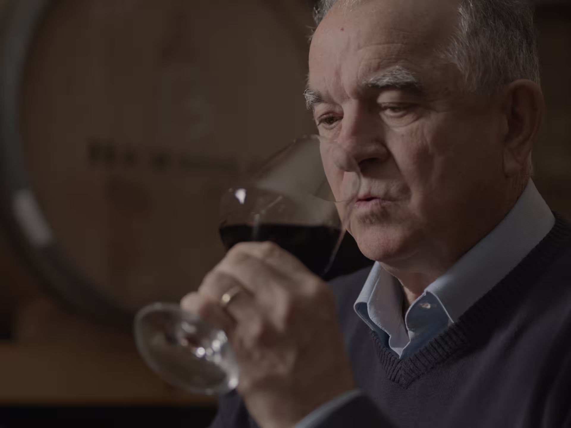 Winemaker smelling red wine during a Perugia winery visit and tasting near Lake Trasimeno, Umbria