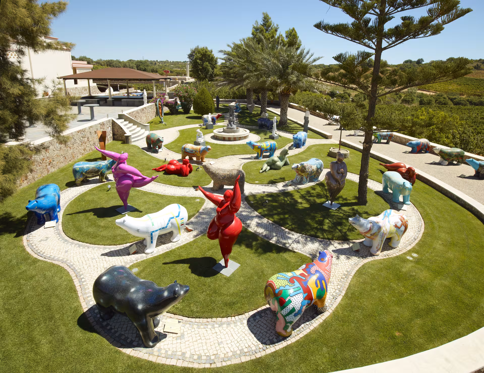 Colorful outdoor sculpture garden at a winery estate offering free-flow wine tasting guided tours open to all visitors