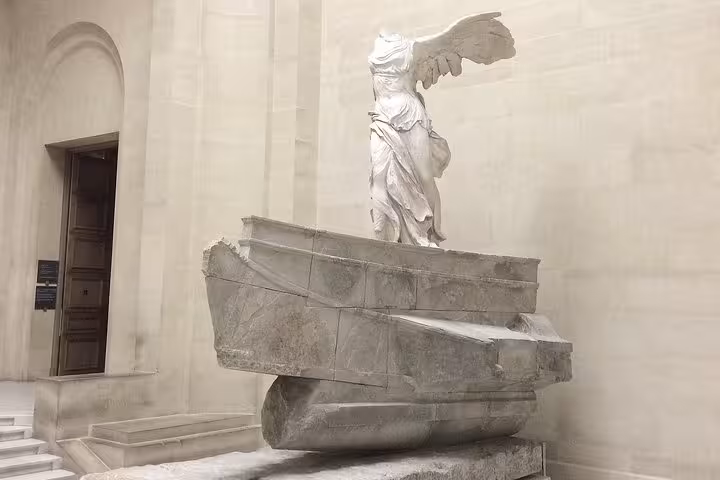 Winged Victory of Samothrace marble statue on ship prow pedestal at the Louvre Museum Paris