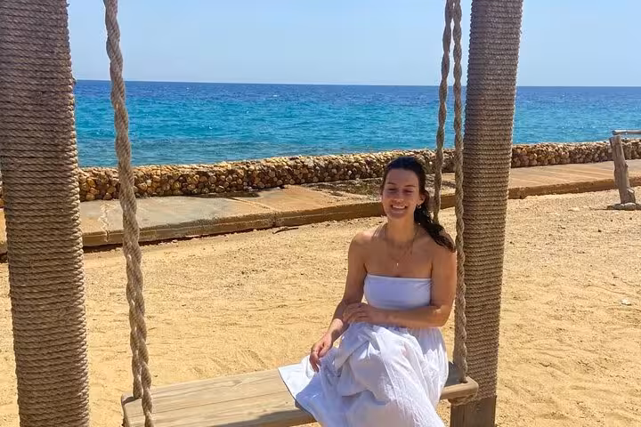 Woman relaxing on a beach swing by the Red Sea in Ain El Sokhna, ideal Cairo day tour seaside escape