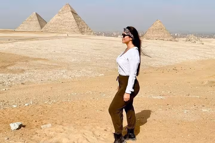 Woman posing at the Giza Pyramids desert viewpoint during all-inclusive Giza tour with pyramid entry and Sphinx
