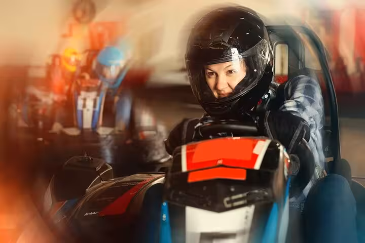 Woman racing a go-kart at Ghibli Raceway in Sharm El-Sheikh, adrenaline karting day tour experience